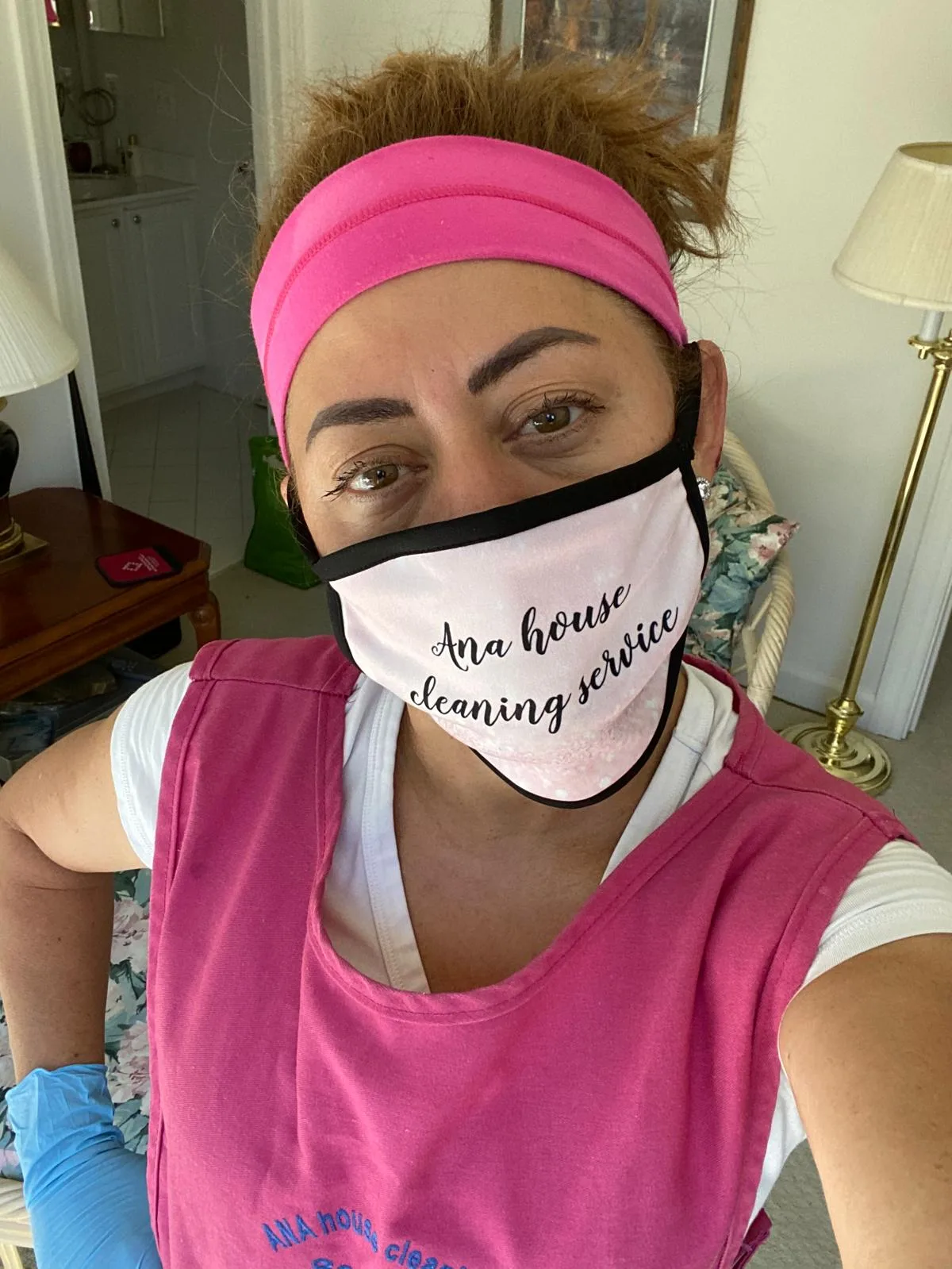 Ana in her cleaning uniform with mask and gloves ready to work