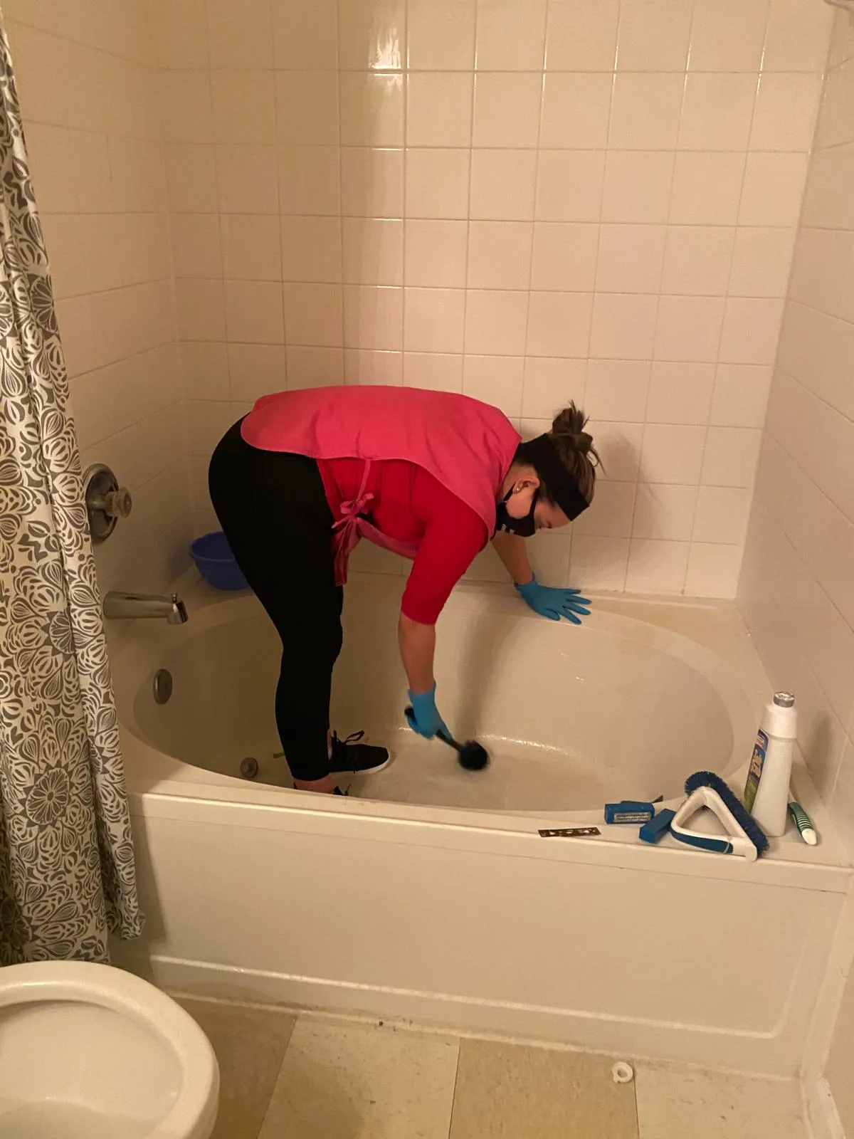 Detailed hand-scrubbing of a tub during a deep clean