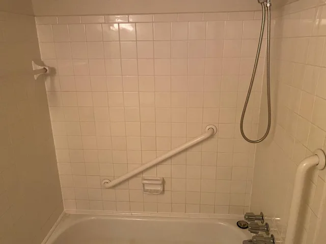 Empty bathroom cleaned for a move with tub and tile bright