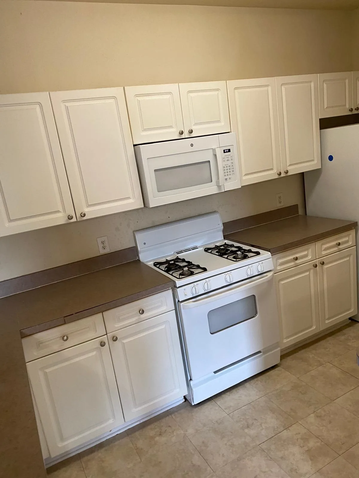 Bright white kitchen cleaned end to end with clear counters